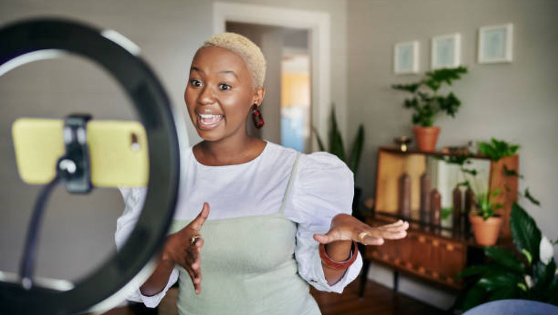 woman recording a video with a ring light